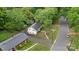 An aerial view of the property nestled among mature trees in a residential neighborhood at 6126 Netherwood Dr, Charlotte, NC 28210