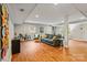 Spacious basement featuring hardwood floors, natural light, and comfortable seating areas at 6126 Netherwood Dr, Charlotte, NC 28210