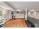 Well-lit basement area offering hardwood floors, comfortable seating, and convenient kitchenette at 6126 Netherwood Dr, Charlotte, NC 28210
