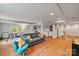 Open basement area with hardwood floors, comfortable seating, and convenient kitchenette at 6126 Netherwood Dr, Charlotte, NC 28210