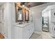 Bright bathroom featuring a double vanity and convenient washer and dryer at 6126 Netherwood Dr, Charlotte, NC 28210