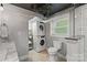 Modern bathroom featuring subway tiled shower, toilet, and stacked laundry machines at 6126 Netherwood Dr, Charlotte, NC 28210