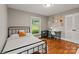 Bedroom featuring hardwood floors and a window view, complemented by a cozy desk area at 6126 Netherwood Dr, Charlotte, NC 28210
