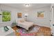 Bedroom featuring hardwood floors, natural lighting, and a colorful rug at 6126 Netherwood Dr, Charlotte, NC 28210