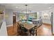 Bright dining area flowing into living room with an island, hardwood floors, and large windows at 6126 Netherwood Dr, Charlotte, NC 28210