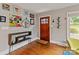 A stylish entryway displays a wooden door, artistic wall decorations, and a modern console table with sleek lines at 6126 Netherwood Dr, Charlotte, NC 28210