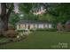 Charming single-story home featuring a well-manicured lawn, inviting walkway, and beautifully landscaped flowerbeds at 6126 Netherwood Dr, Charlotte, NC 28210