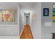 Hallway features hardwood floors and neutral paint, creating a seamless transition between rooms at 6126 Netherwood Dr, Charlotte, NC 28210