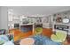 Open-concept living area with a kitchen, including an island, stainless appliances, and a wooden dining table set at 6126 Netherwood Dr, Charlotte, NC 28210
