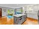 Open-concept kitchen features a gray island, stainless steel appliances and connects to a living space at 6126 Netherwood Dr, Charlotte, NC 28210