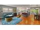 Inviting living room flowing into a kitchen features an island with counter seating and updated stainless steel appliances at 6126 Netherwood Dr, Charlotte, NC 28210