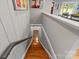 View down the hardwood staircase featuring modern railing and access to living areas at 6126 Netherwood Dr, Charlotte, NC 28210