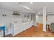 Basement wet bar with white cabinets, marble countertop, and stylish lighting fixtures at 6126 Netherwood Dr, Charlotte, NC 28210