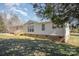 Home's side exterior featuring classic siding, complemented by a wooden deck and a glimpse of the surrounding greenery at 620 Debruhl Rd, Chester, SC 29706