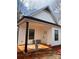 Inviting view of home showcasing a covered porch, white siding, and dark trim at 625 Academy St, Cleveland, NC 27013