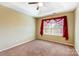 Carpeted bedroom featuring a ceiling fan and a window with a red sheer curtain at 631 Winding Branch Rd, Rock Hill, SC 29732