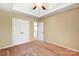 Neutral bedroom featuring a ceiling fan, tray ceiling, carpet floors, and double-door closet at 631 Winding Branch Rd, Rock Hill, SC 29732