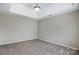 Neutral carpeted bedroom with a tray ceiling and a modern light fixture at 631 Winding Branch Rd, Rock Hill, SC 29732