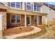 Inviting front porch with stone accents and walkway, leading to a charming home exterior and well maintained garden at 631 Winding Branch Rd, Rock Hill, SC 29732