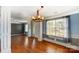 Spacious living room featuring hardwood floors, elegant trim, large window, and chandelier at 631 Winding Branch Rd, Rock Hill, SC 29732