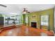 Cozy living room featuring hardwood floors, fireplace, and an open floor plan leading to the kitchen at 631 Winding Branch Rd, Rock Hill, SC 29732