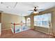 Carpeted loft area with white railings, a chandelier, and a window with sheer curtains at 631 Winding Branch Rd, Rock Hill, SC 29732