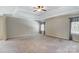 Spacious carpeted main bedroom featuring a trey ceiling and ceiling fan at 631 Winding Branch Rd, Rock Hill, SC 29732