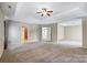 Large main bedroom with carpet and tray ceiling, showing access to other rooms at 631 Winding Branch Rd, Rock Hill, SC 29732