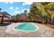 Backyard pool with stone surround, covered gazebo, wood fence and mature trees at 631 Winding Branch Rd, Rock Hill, SC 29732