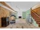 Basement featuring concrete floors, fireplace, and wooden staircase at 710 Peranna Pl, Charlotte, NC 28211