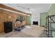 Unfinished basement featuring wood paneled walls, brick fireplace, and a treadmill for exercise at 710 Peranna Pl, Charlotte, NC 28211