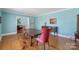 Bright dining room featuring hardwood floors, neutral walls, and a beautiful buffet table at 710 Peranna Pl, Charlotte, NC 28211