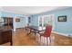 Dining room featuring hardwood floors, neutral walls, and a vintage china cabinet at 710 Peranna Pl, Charlotte, NC 28211