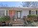 Charming front porch with brick steps, black railings, and decorative plants at 710 Peranna Pl, Charlotte, NC 28211