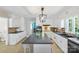 Bright, spacious kitchen with white cabinetry, island, tile backsplash, and modern appliances at 710 Peranna Pl, Charlotte, NC 28211