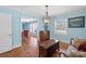 Comfortable living room with wood floors, an antique trunk, and blue walls and trim at 710 Peranna Pl, Charlotte, NC 28211