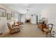 Cozy living room featuring a brick fireplace, neutral decor, built in bookshelf, and comfortable seating at 710 Peranna Pl, Charlotte, NC 28211