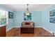 Sitting room featuring hardwood floors, natural light, and artwork at 710 Peranna Pl, Charlotte, NC 28211