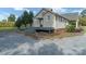 Home exterior with deck, gray gravel, and cornfield in background at 7740 Us 52 Hwy, Salisbury, NC 28146