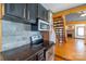 Kitchen featuring stainless steel appliances, dark wood cabinets, and brick accents at 7740 Us 52 Hwy, Salisbury, NC 28146