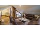 Upstairs living area with natural light, comfortable seating, brick detail, and carpet floors at 7740 Us 52 Hwy, Salisbury, NC 28146