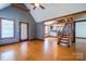 Hardwood floor living room features exposed wooden beam and staircase with a kitchen view at 7740 Us 52 Hwy, Salisbury, NC 28146