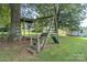 Outdoor wooden playground structure featuring a slide and tree fort for backyard fun at 7740 Us 52 Hwy, Salisbury, NC 28146