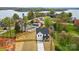 An aerial view of a newly built home and its large lot fenced for privacy near a peaceful, wooded lake at 9615 Riviera Dr, Sherrills Ford, NC 28673