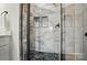 Close up of a glass-enclosed shower featuring marble accents and modern fixtures at 9615 Riviera Dr, Sherrills Ford, NC 28673