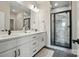 Modern bathroom with double vanity, marble countertops, and a glass-enclosed shower with marble accents at 9615 Riviera Dr, Sherrills Ford, NC 28673