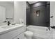 Bathroom featuring modern finishes with a tiled wall, bathtub, shower, vanity, and mirror at 9615 Riviera Dr, Sherrills Ford, NC 28673