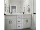 Bathroom featuring double sink vanity with sleek black hardware and shaker-style cabinets at 9615 Riviera Dr, Sherrills Ford, NC 28673