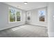 Bright bedroom with three windows that boast outside views and neutral walls with carpet at 9615 Riviera Dr, Sherrills Ford, NC 28673