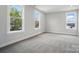 Bright bedroom features three windows that boast outside views and neutral walls with carpet at 9615 Riviera Dr, Sherrills Ford, NC 28673